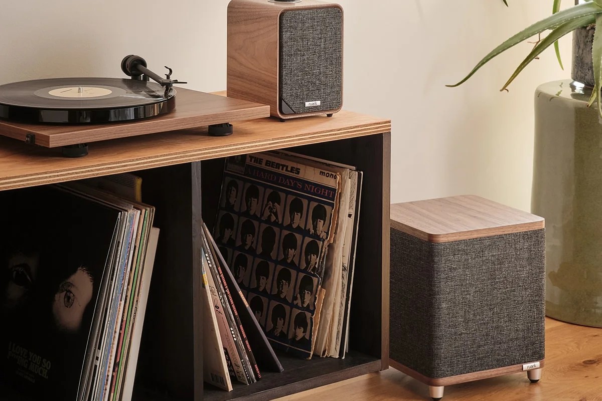 The walnut subwoofer at the foot of a record cabinet, with an MR1 speaker and a turntable above