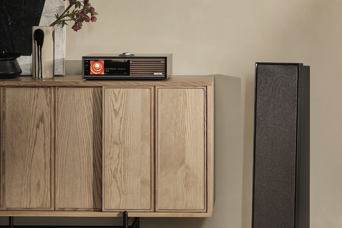 Floorstanding speaker beside a light wood sideboard