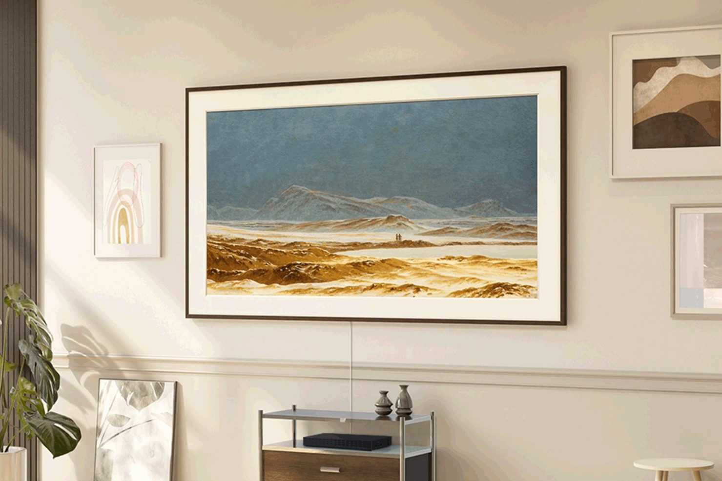 Mountain landscape shown in Art Mode above a console, box on the shelf
