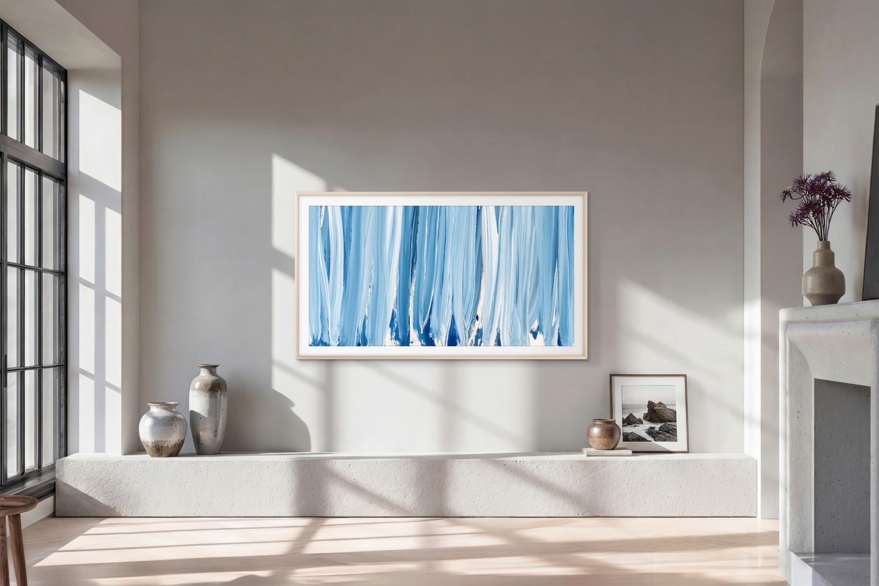 Minimalist living room, screen mounted flat on a grey wall with no visible cable