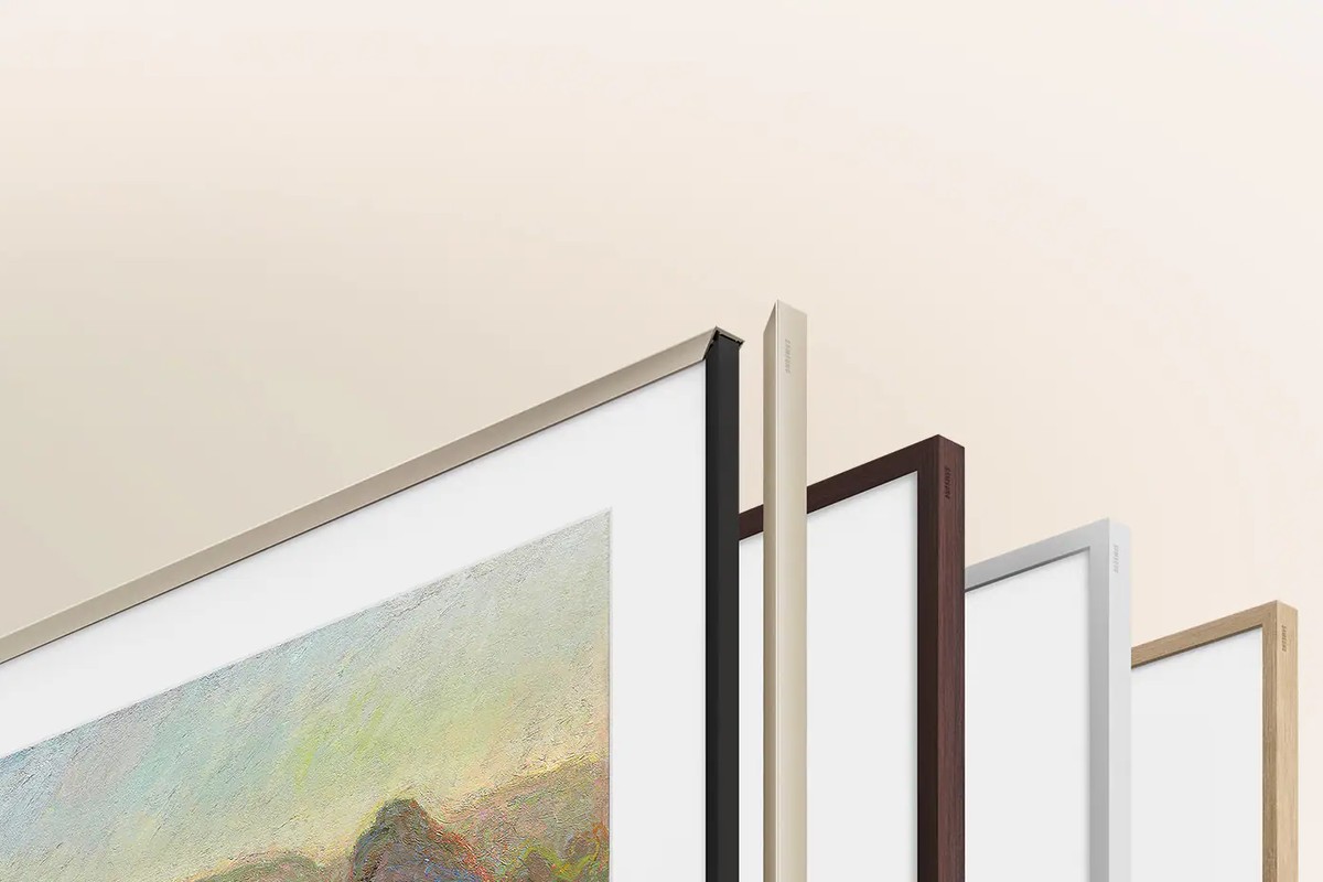 The four The Frame bezel finishes lined up: gold metal, walnut, white, teak