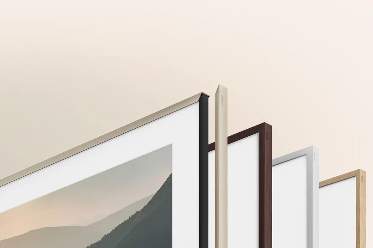 The four The Frame bezel finishes lined up: gold metal, walnut, white, teak