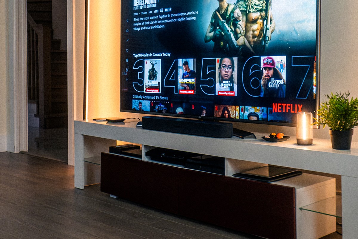Wall-mounted television, soundbar and hub on a low cabinet
