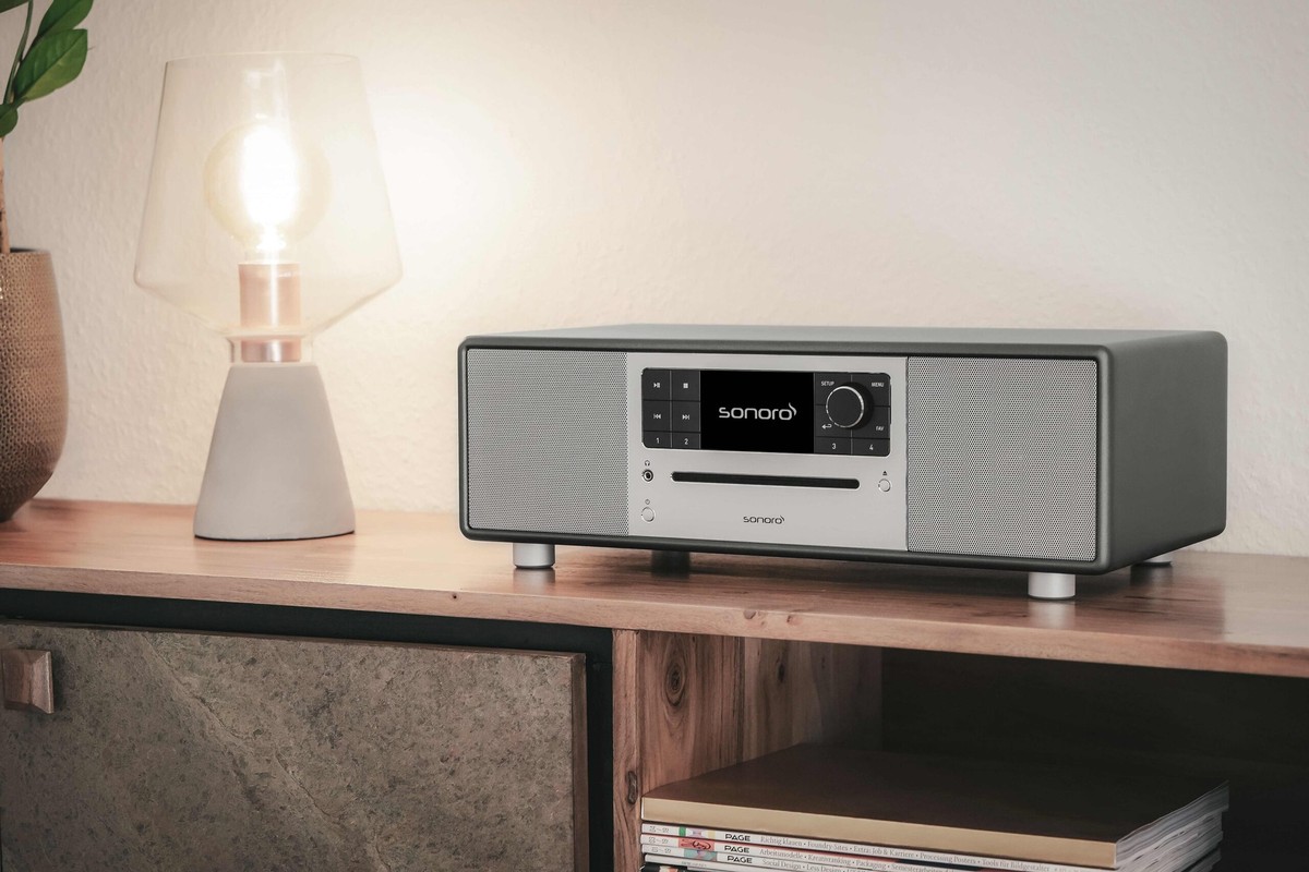 Compact graphite system on a wooden sideboard next to a lit lamp