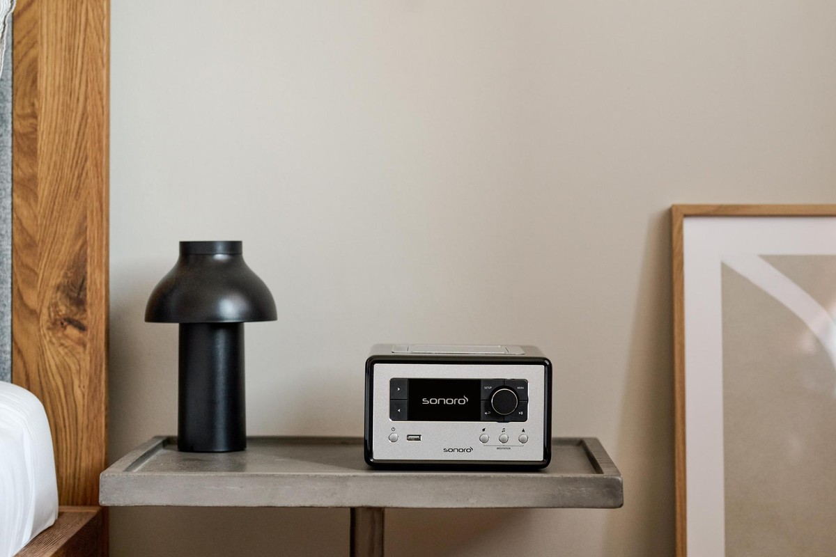 Black Sonoro Relax on a concrete bedside table next to a lamp