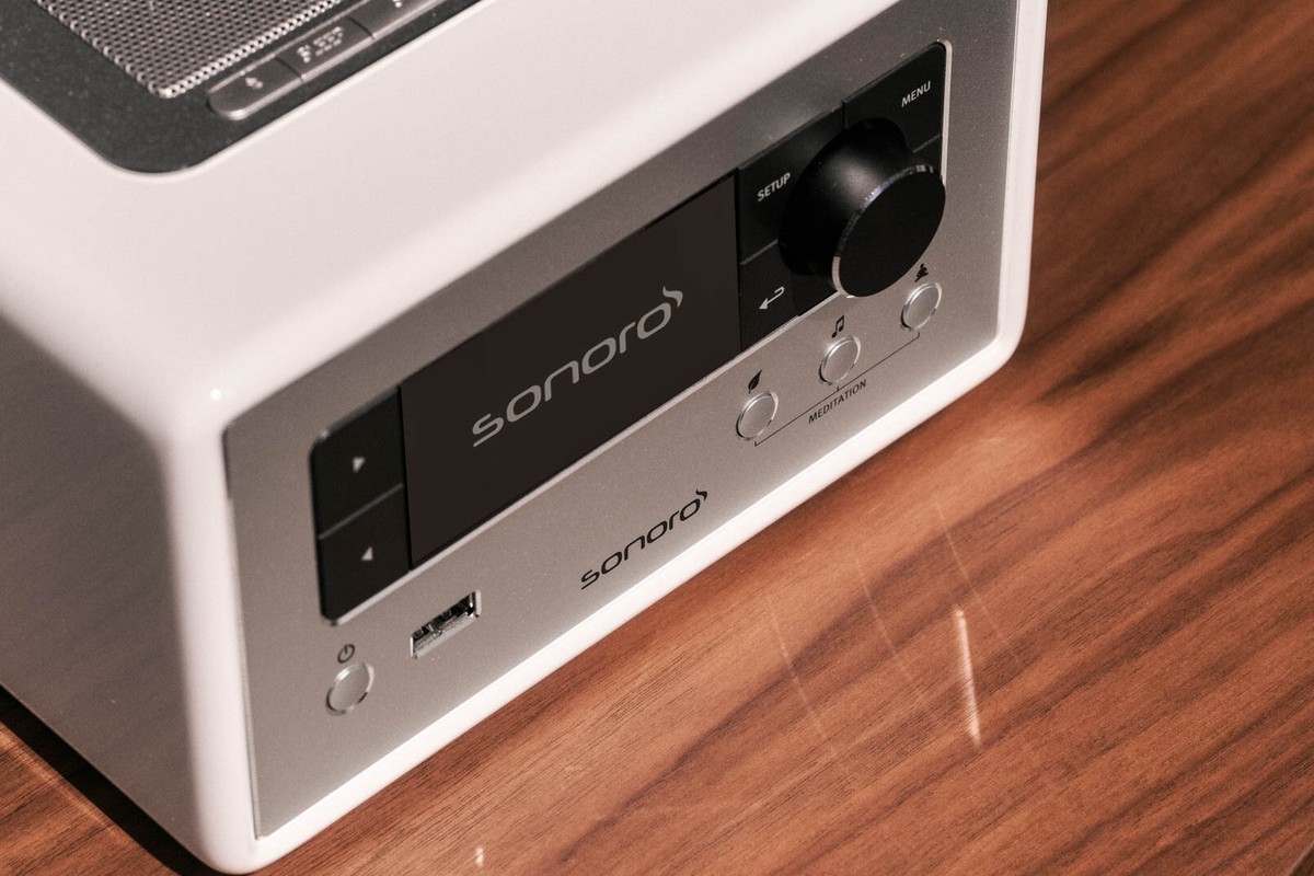 Close-up of the glossy white front with the display and USB port