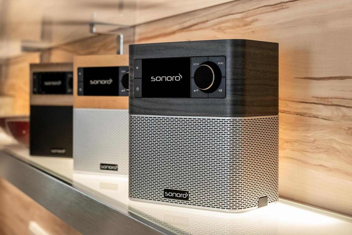 Three radios lined up on a worktop, each in a different wood decor