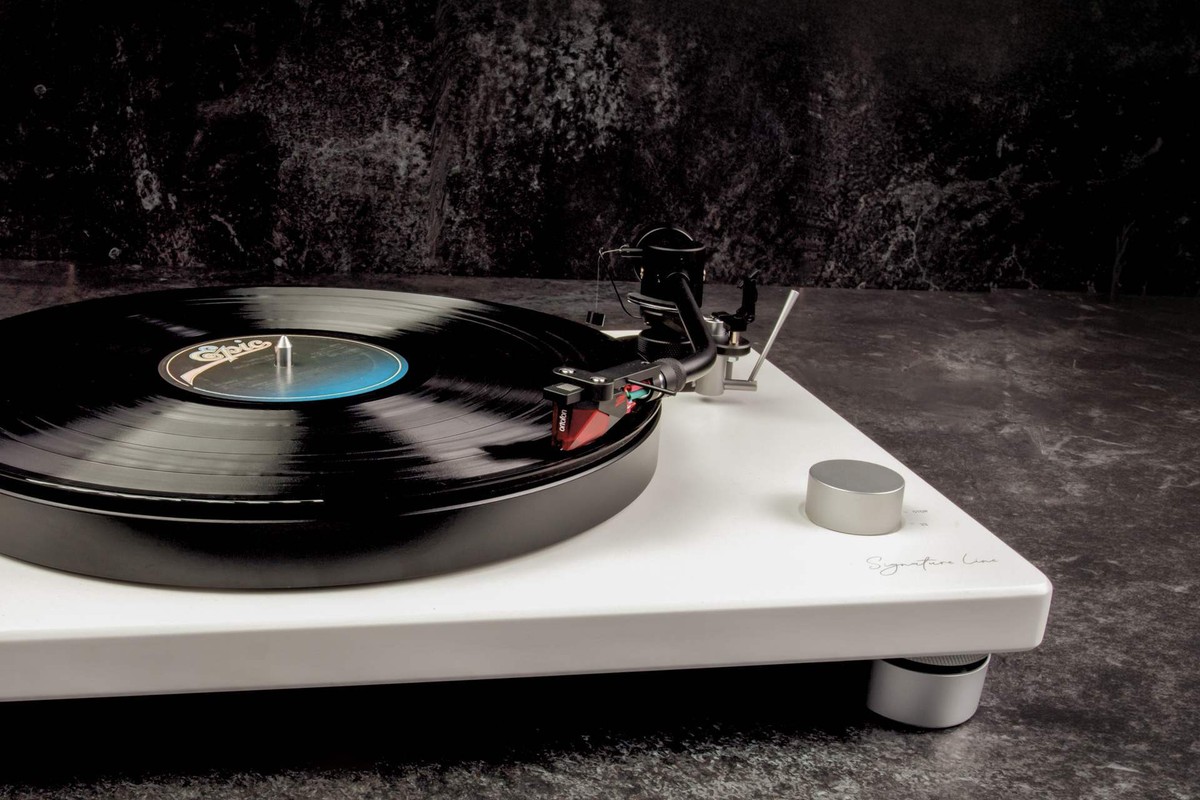 Disco in vinile su un giradischi bianco, braccio appoggiato nel solco