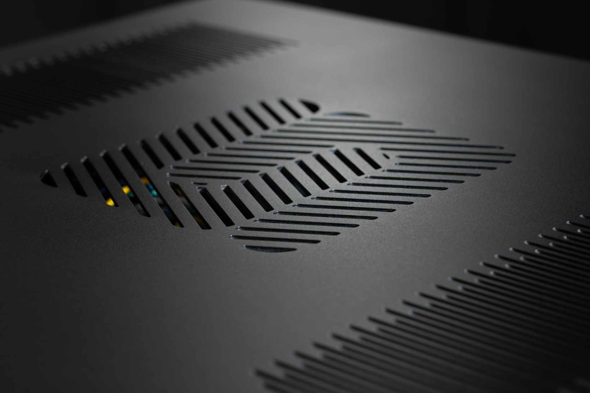 Close-up of the vented black top cover, components visible under the grille