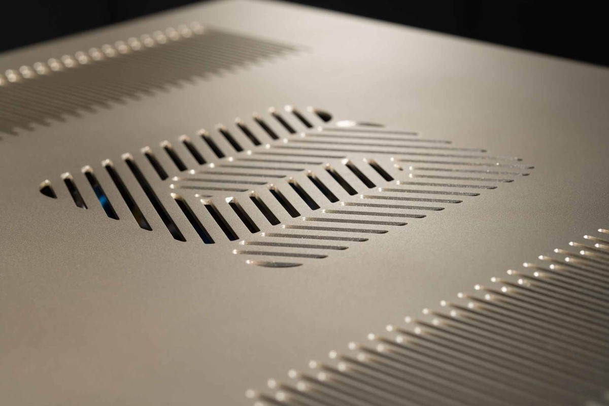 Close-up of the gold-finish top cover and its ventilation slots
