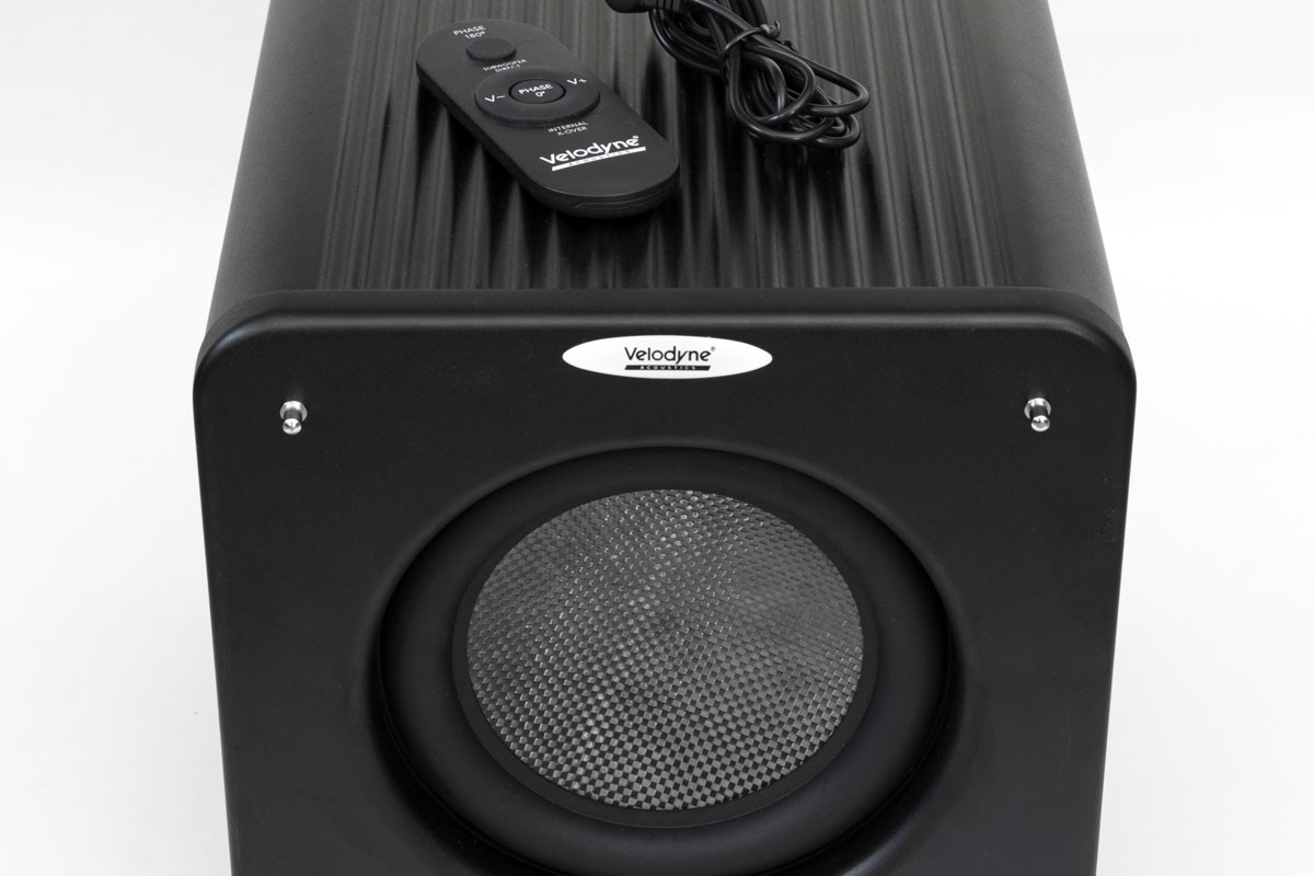 Compact subwoofer with its remote control on top