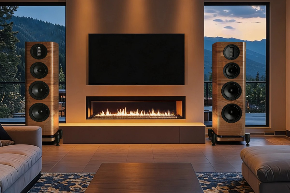 Two walnut towers on either side of a television and a fireplace in a large living room