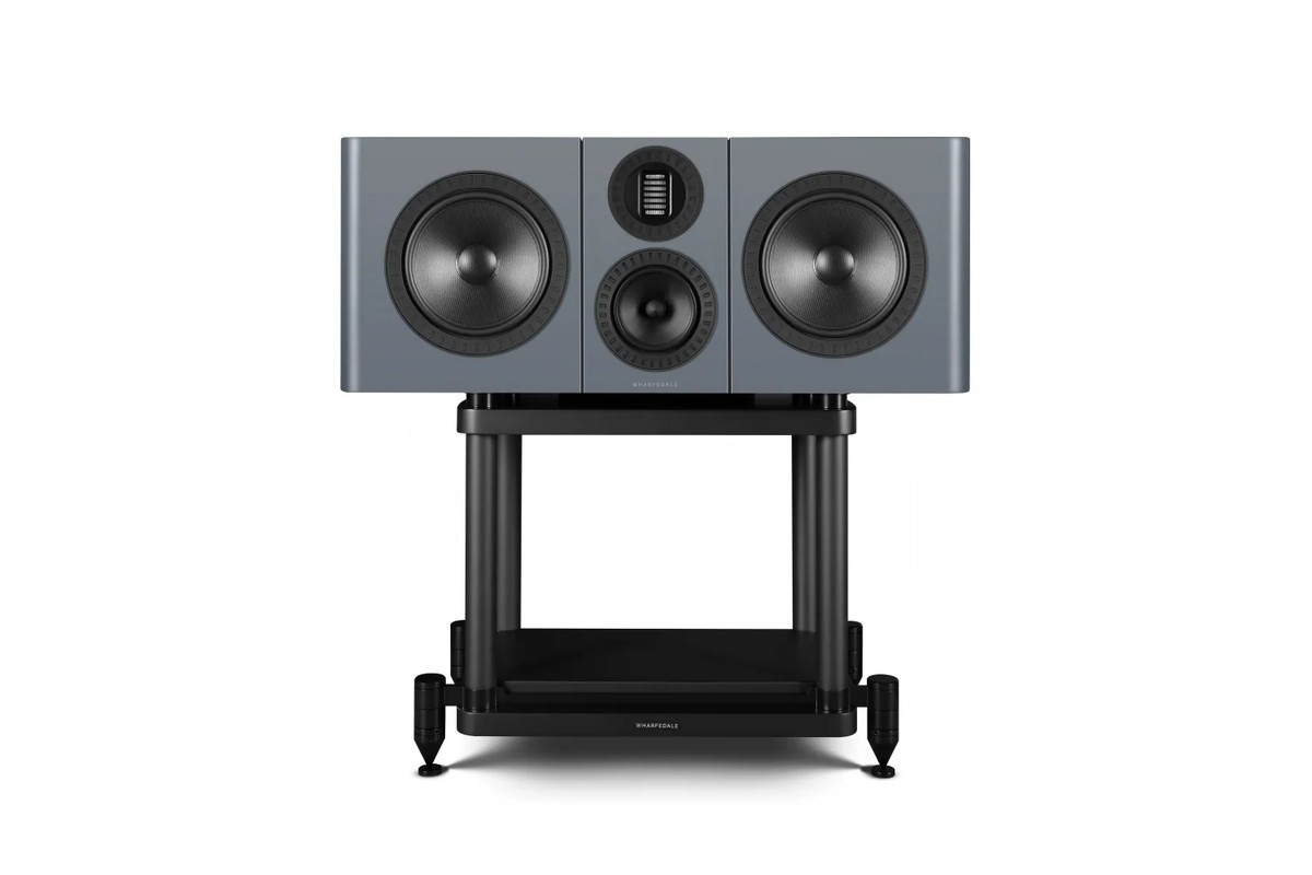 A grey centre speaker on a black stand, seen from the front on a white background