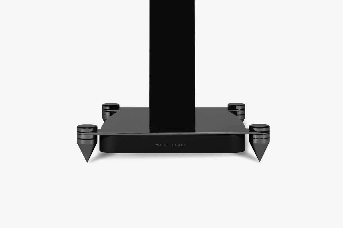 Black base of a stand with its metal spikes, front view