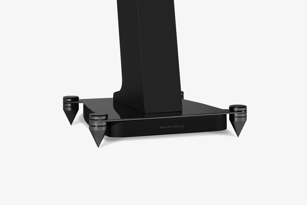 Black base of a stand with its metal spikes, three-quarter view