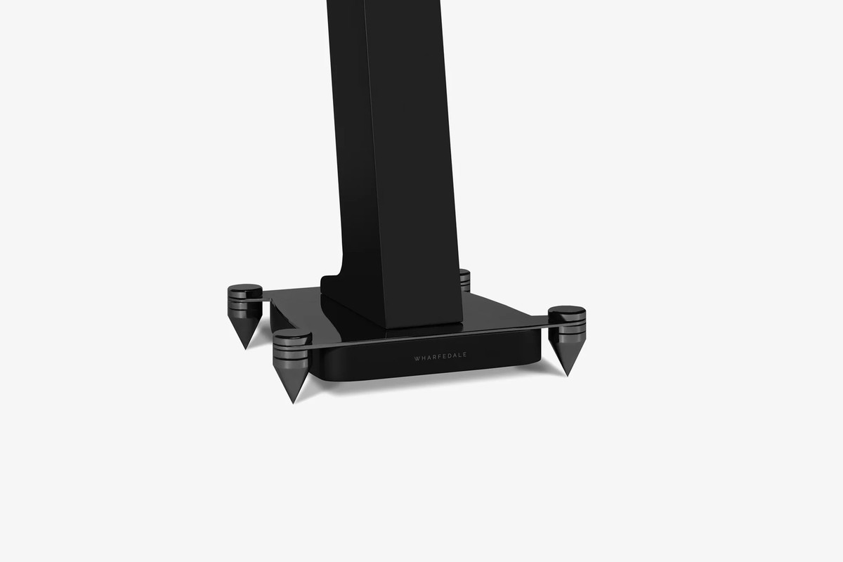 Black base of a stand with its metal spikes, three-quarter view