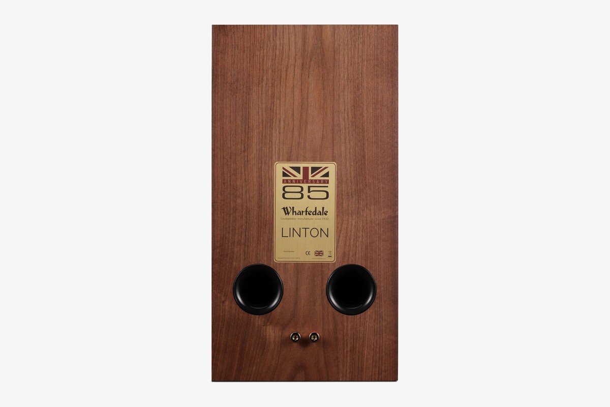 Back of a walnut speaker with its two ports and binding posts