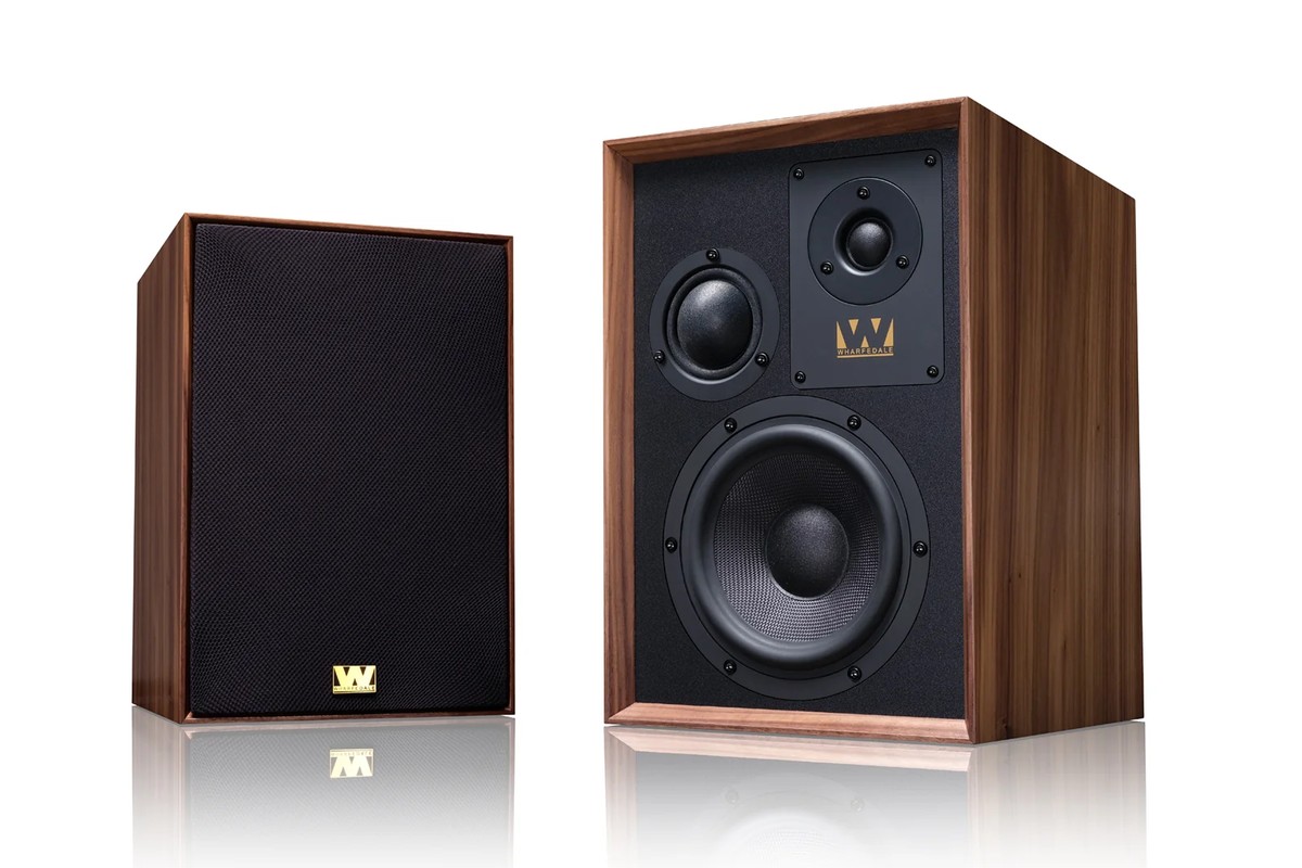 Two walnut speakers, one with its black cloth grille, the other with the front bare