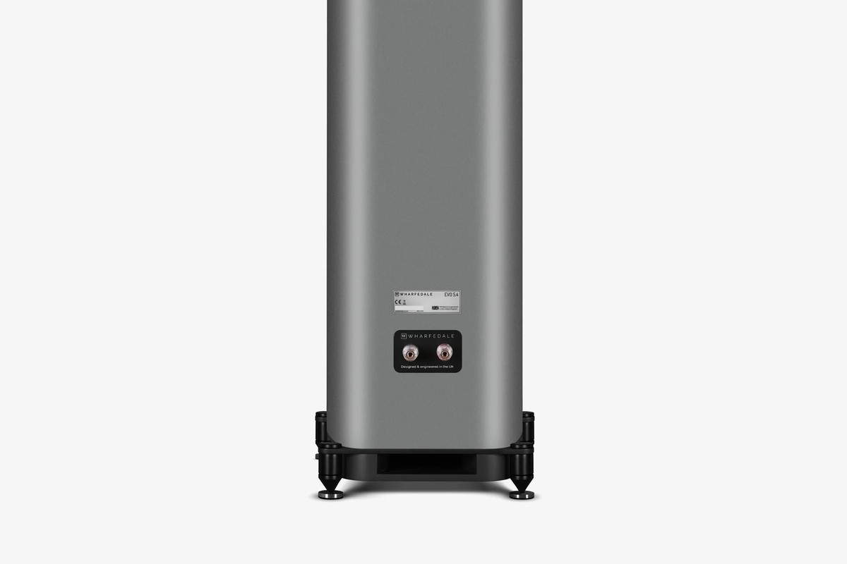 Rear of a grey floorstanding speaker with its binding posts and its plinth on feet