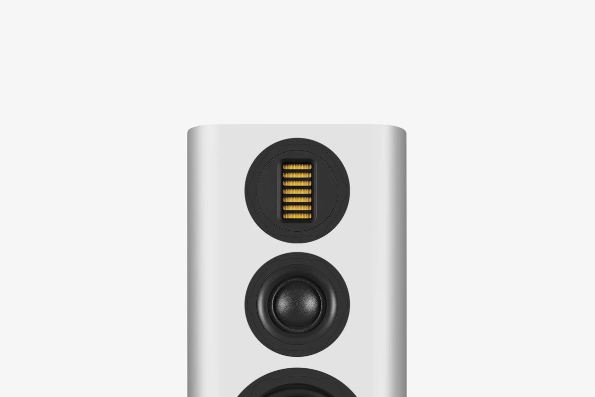 Upper part of a white bookshelf speaker seen from the front with its AMT tweeter