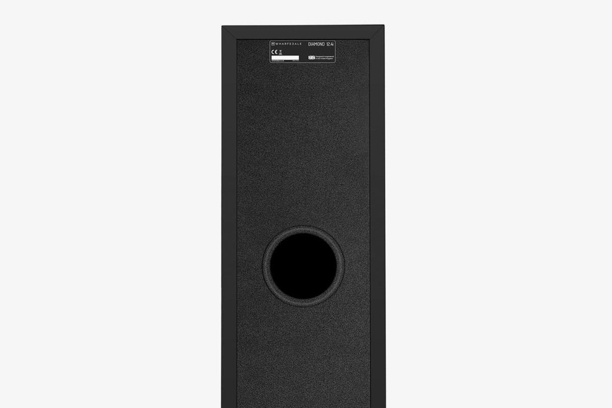 Back of a black speaker with its circular port and rating plate