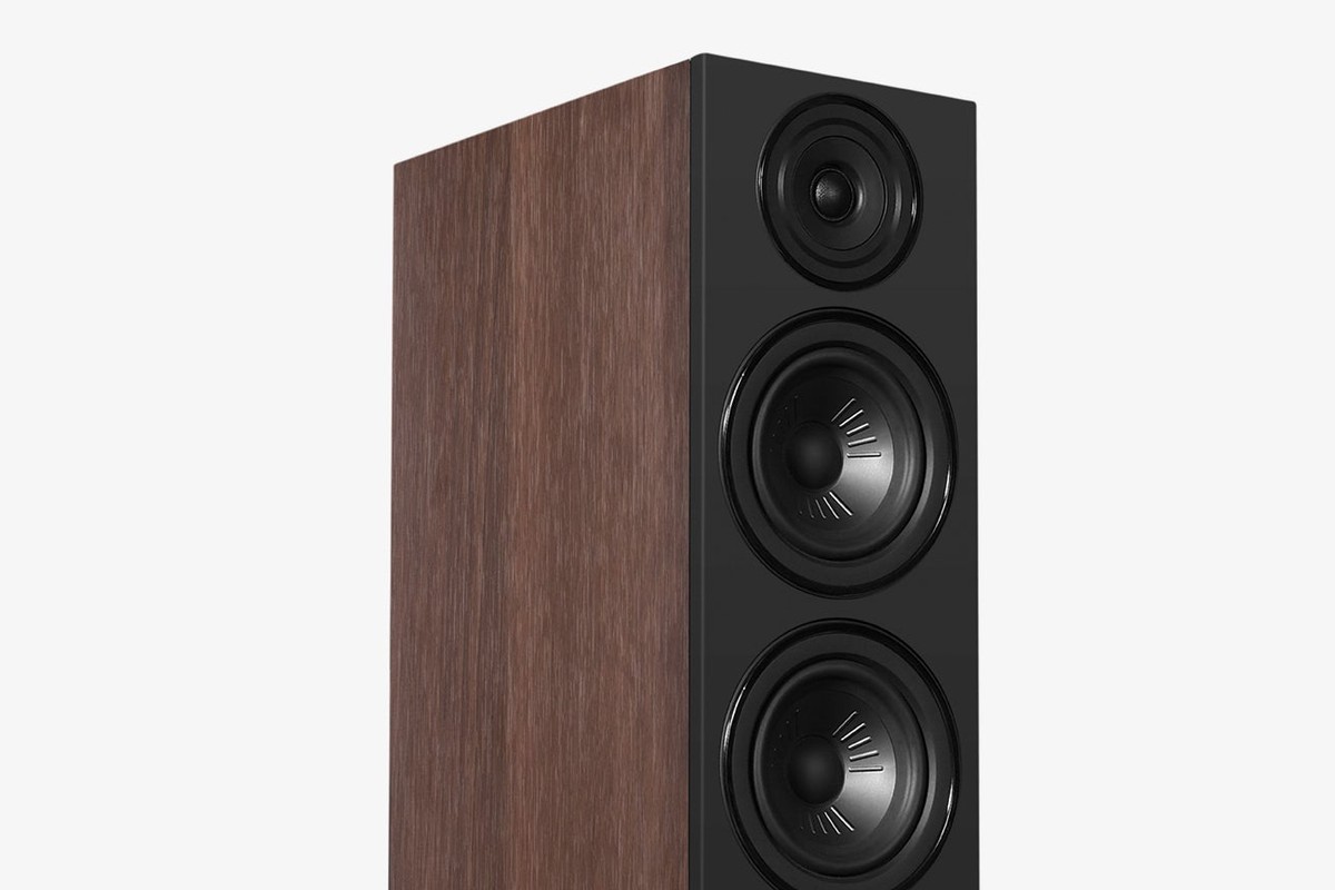 Walnut speaker with a black baffle seen at three-quarter angle