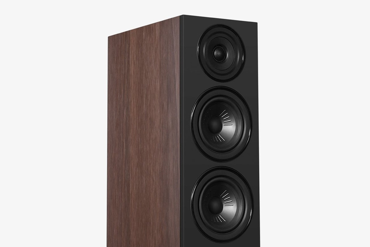 Walnut speaker with a black baffle seen at three-quarter angle