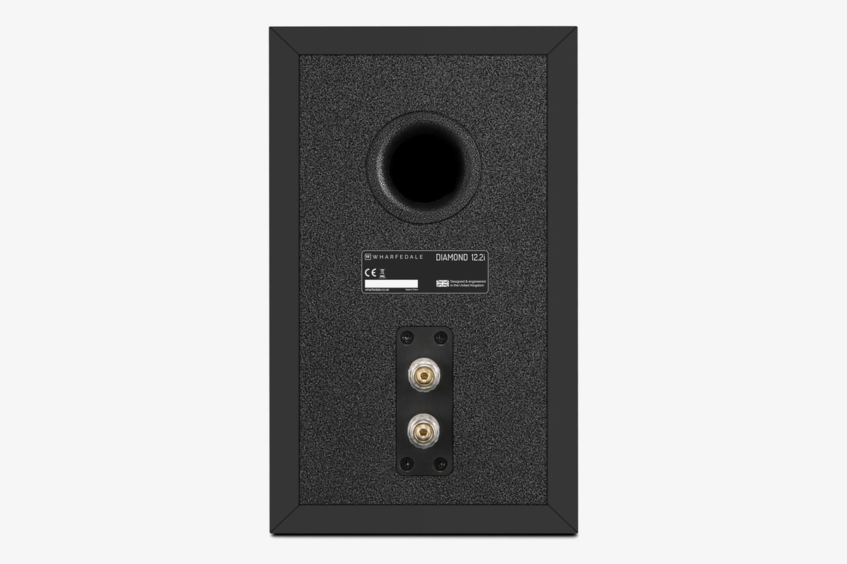 Back of a black speaker with its port, rating plate and terminals