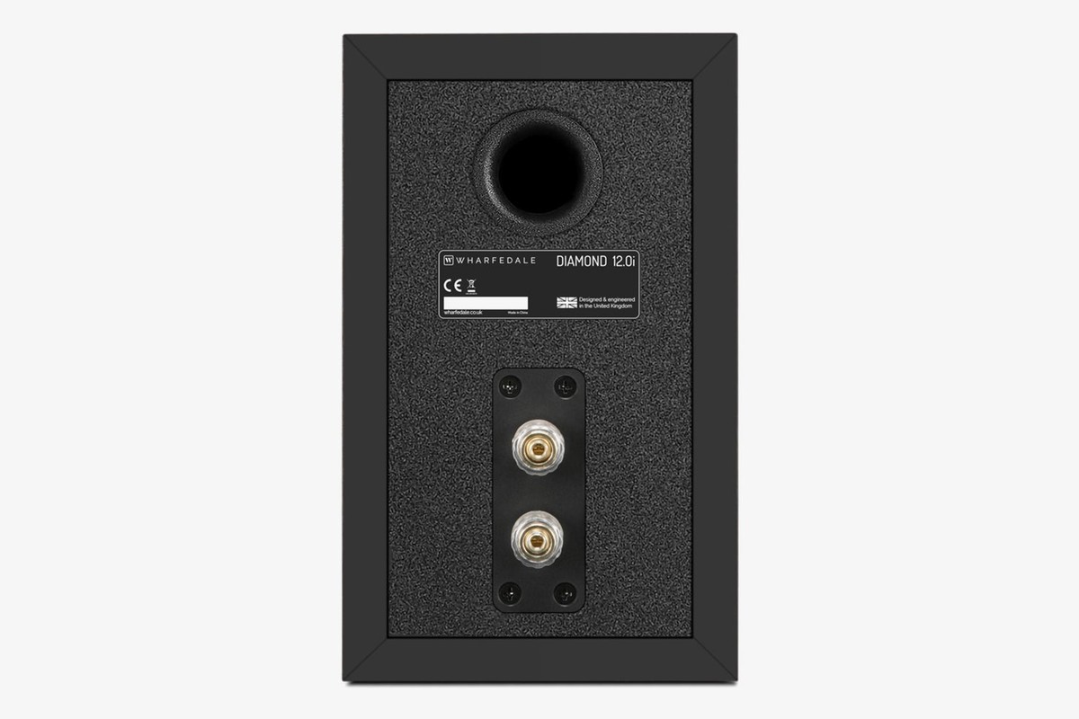 Back of a black speaker with its port, rating plate and terminals