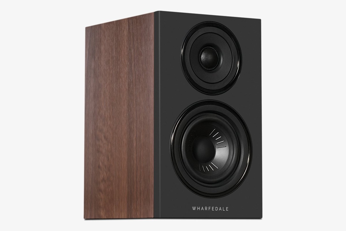 Walnut speaker with a black baffle seen at three-quarter angle