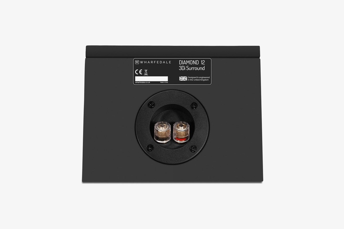 Back of a black speaker with its rating plate and recessed connection terminal