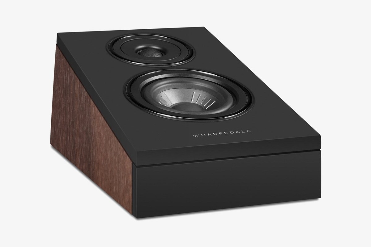 Speaker with an angled front and walnut side seen at three-quarter angle