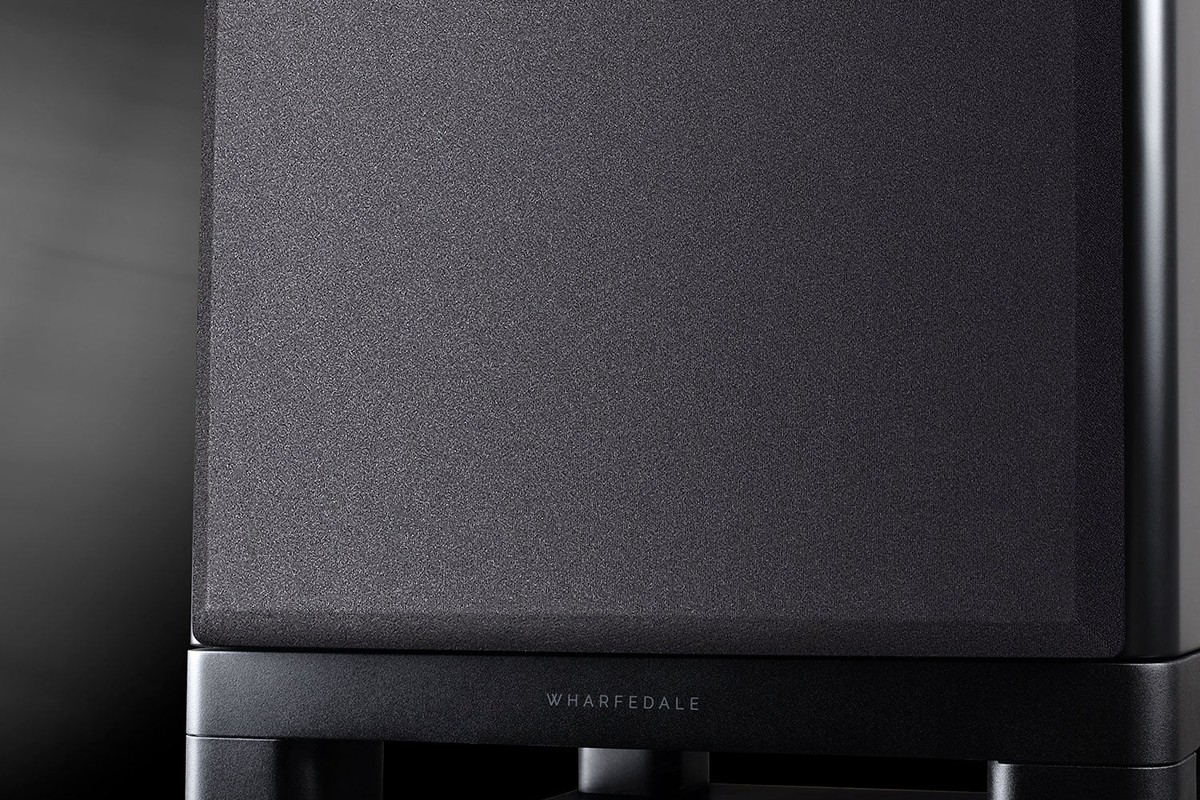 Front of the subwoofer with its black grille and the brand name on the base