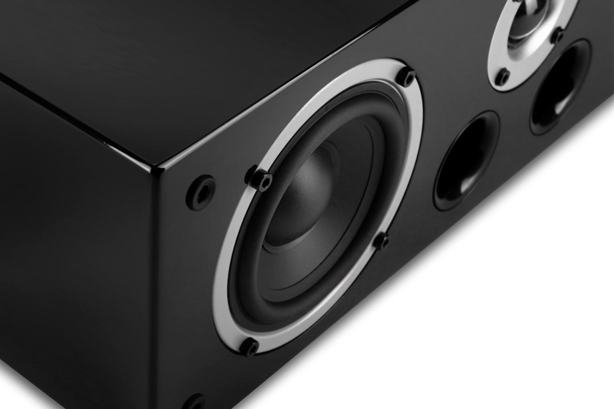 Corner of a black lacquered cabinet with driver, tweeter and ports