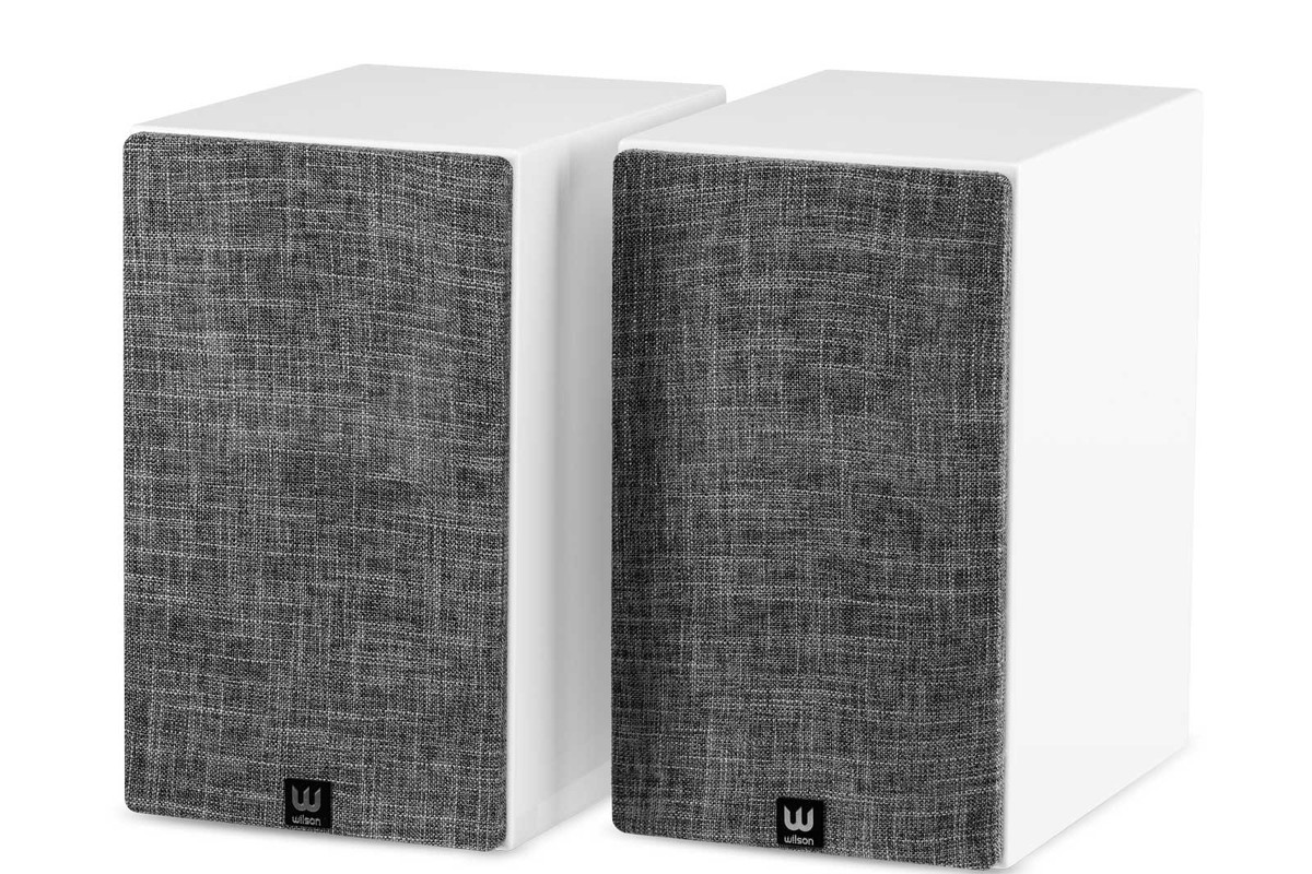 Two white bookshelf speakers fitted with grey grilles