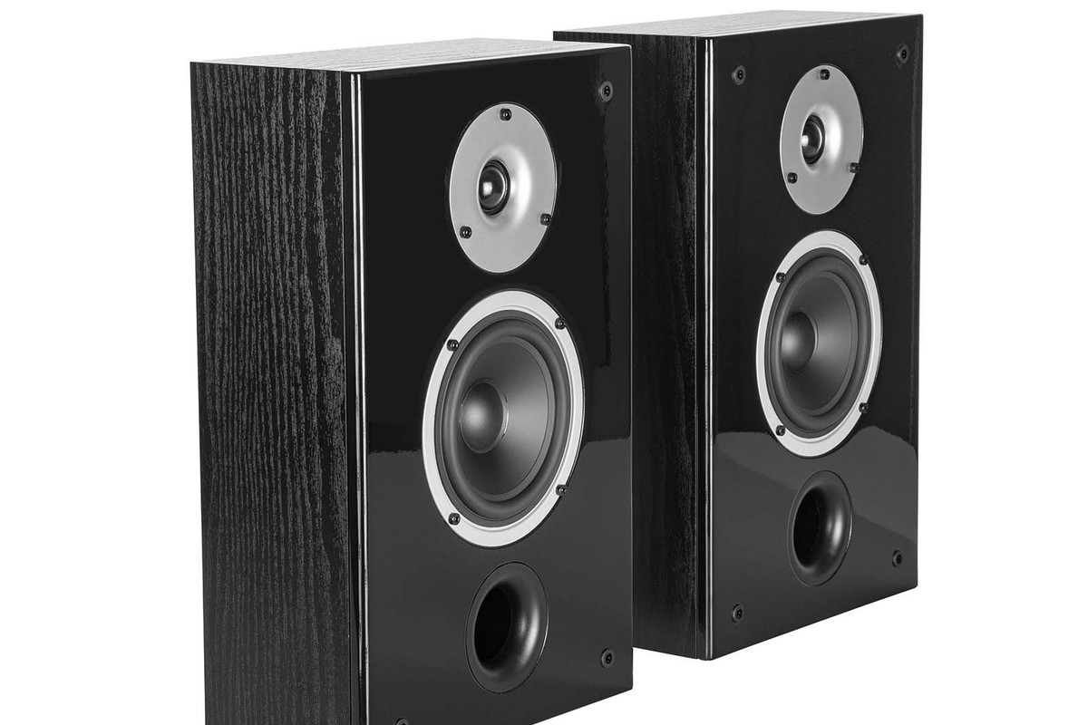 Pair of black on-wall speakers seen from three quarters, with dome, midrange driver and front port