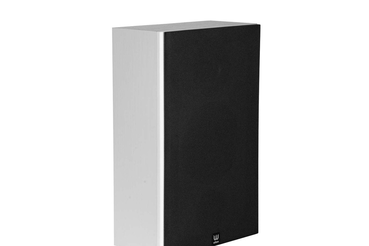White cabinet with wood structure, seen from three quarters, with a black fabric grille