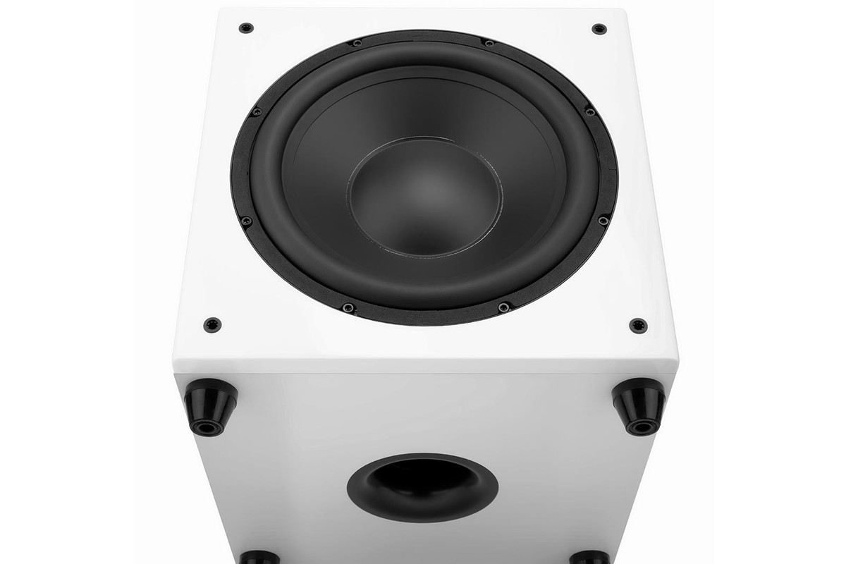 White subwoofer seen from below: driver on the front and circular port under the cabinet