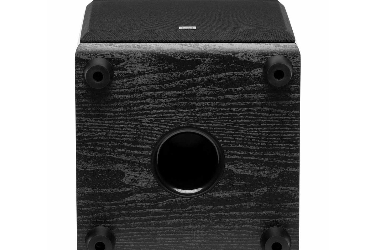 Underside of the black subwoofer with the circular port and four feet