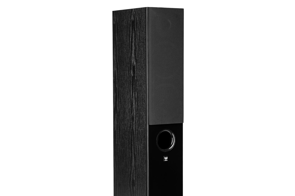 Black cabinet with wood-grain structure, black fabric grille on the upper part and front port