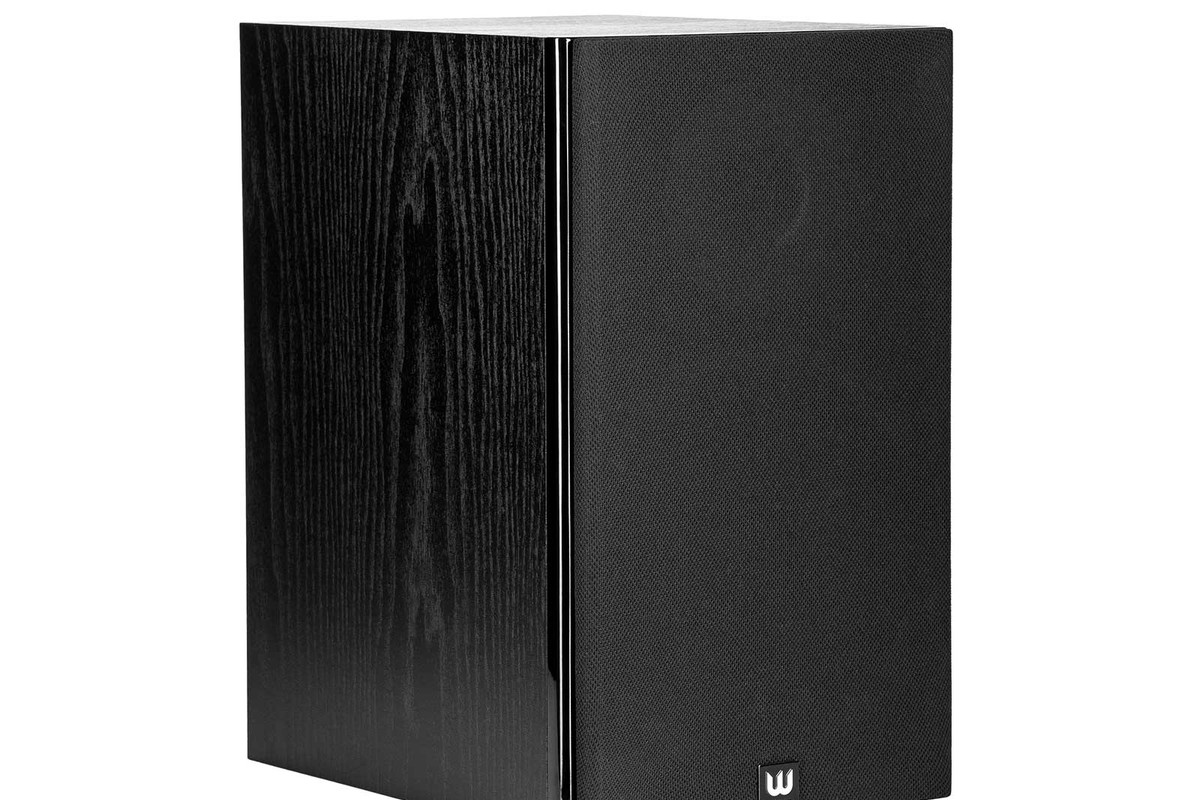 Black wood-grain cabinet seen from three quarters, black fabric grille placed on the front
