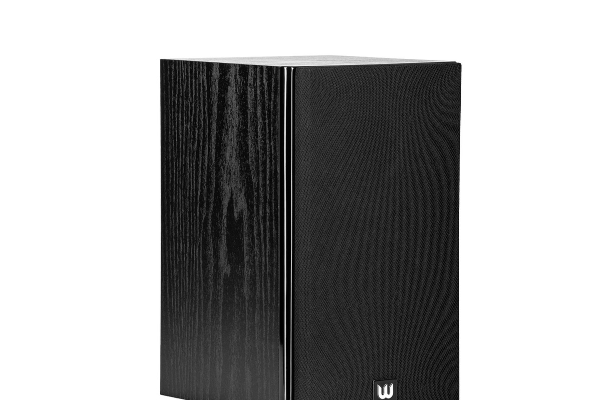 Black wood-grain speaker seen from three quarters with its fabric grille and the brand logo