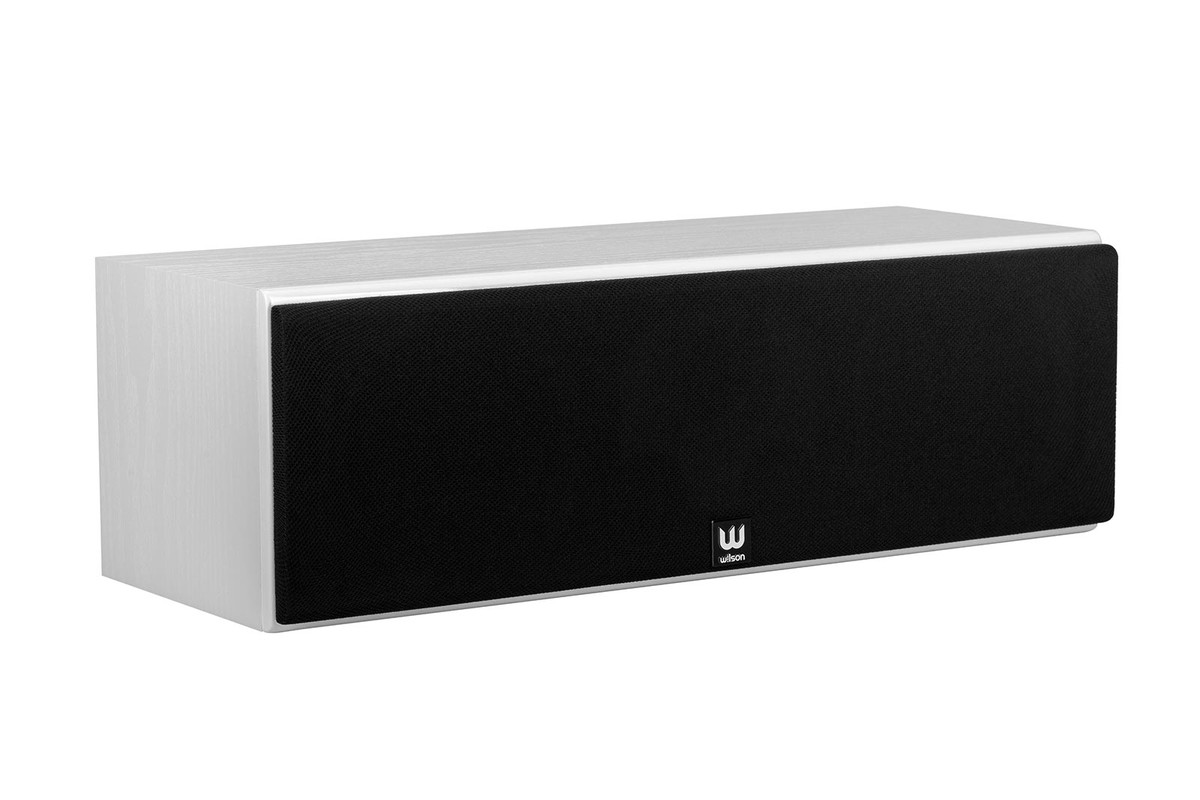 White centre speaker with its black grille, seen from three quarters