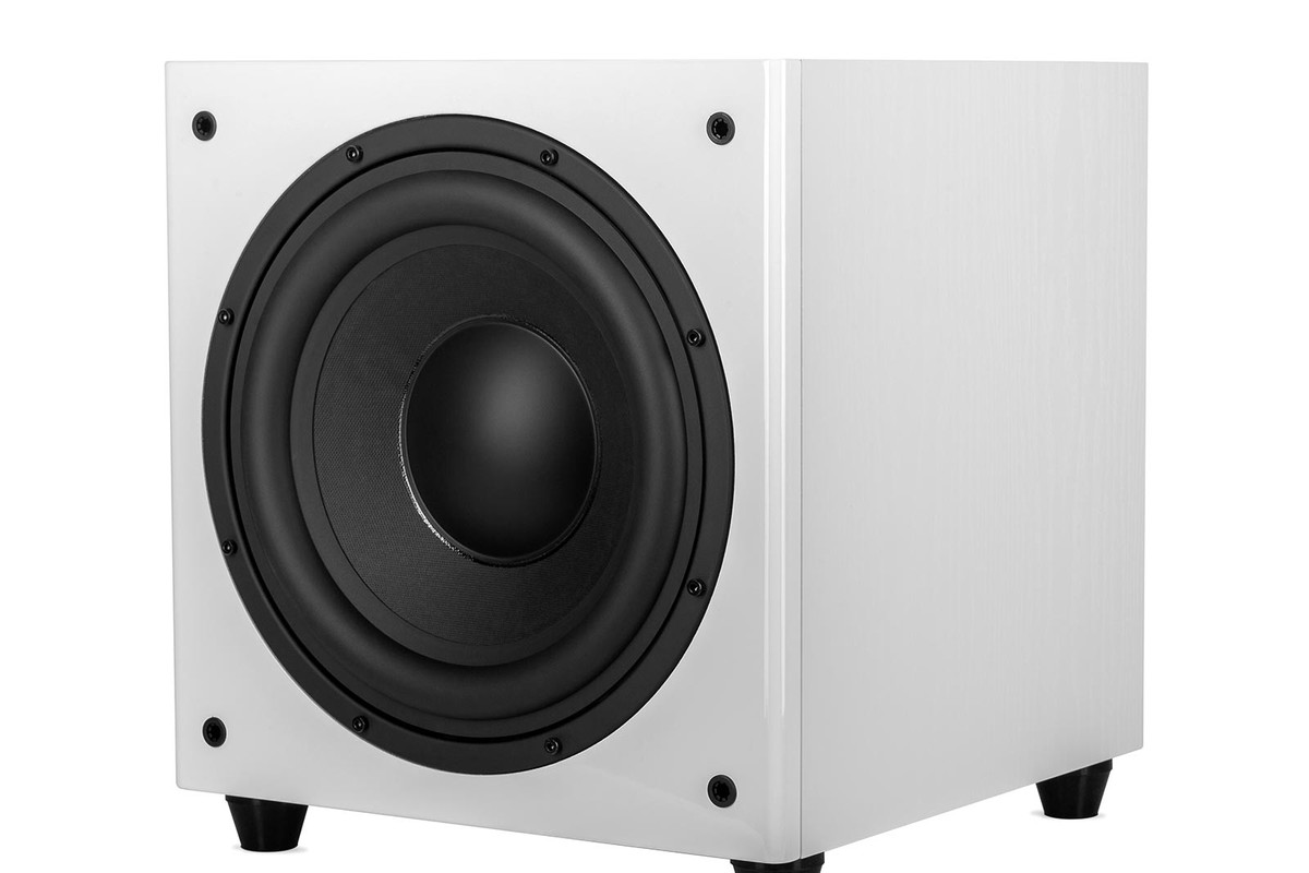 White subwoofer seen from three quarters, bass driver and veined side