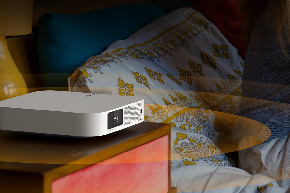 XGIMI Elfin on a bedside table lighting a bedroom wall
