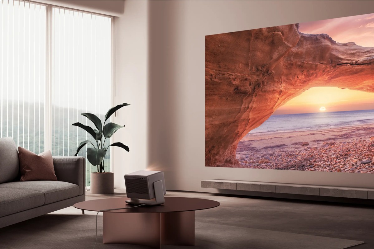 Living room bathed in daylight, cliff landscape projected large above a low cabinet