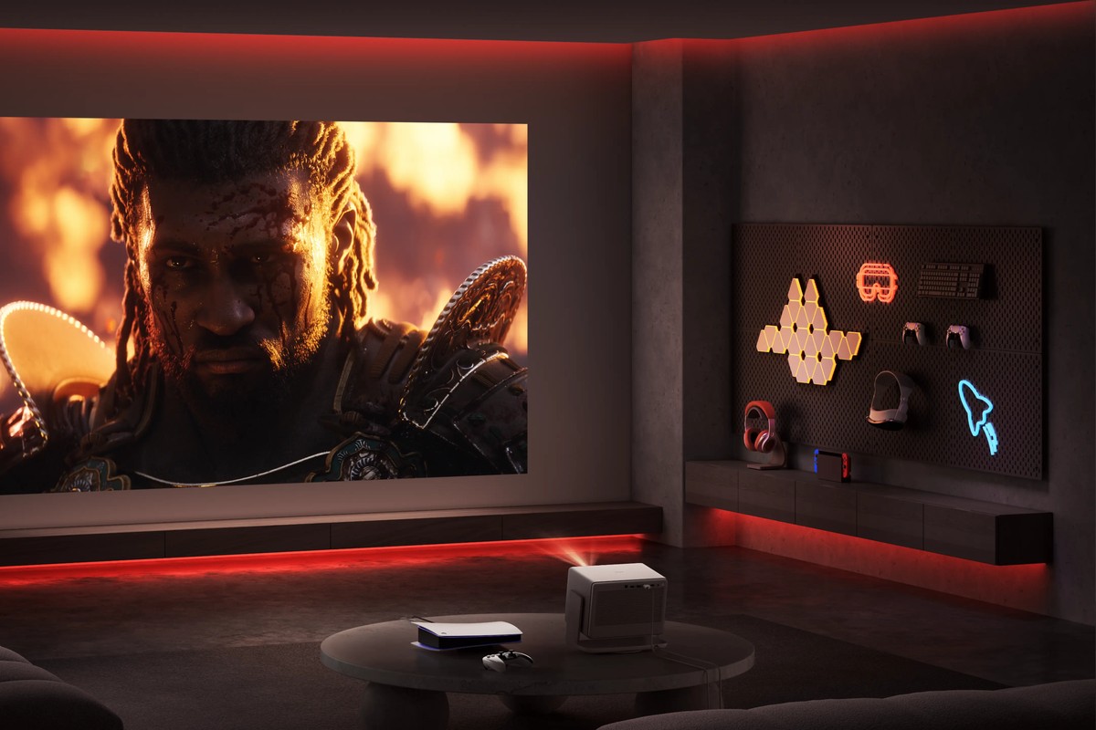 Games room lit by red neon, video game character projected across the full width of the wall