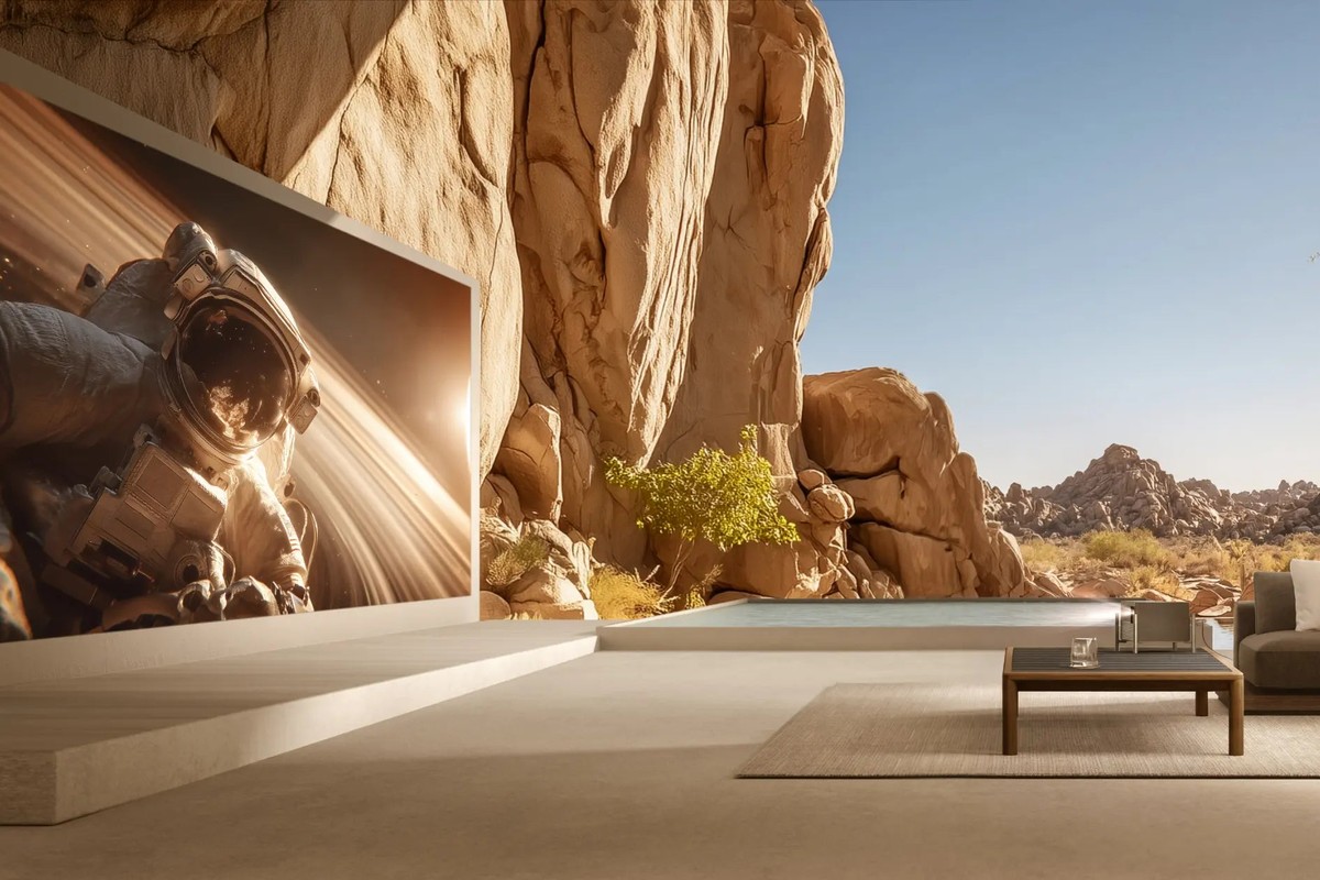 Large open-plan living room in broad daylight, image of an astronaut projected on a wall several metres wide