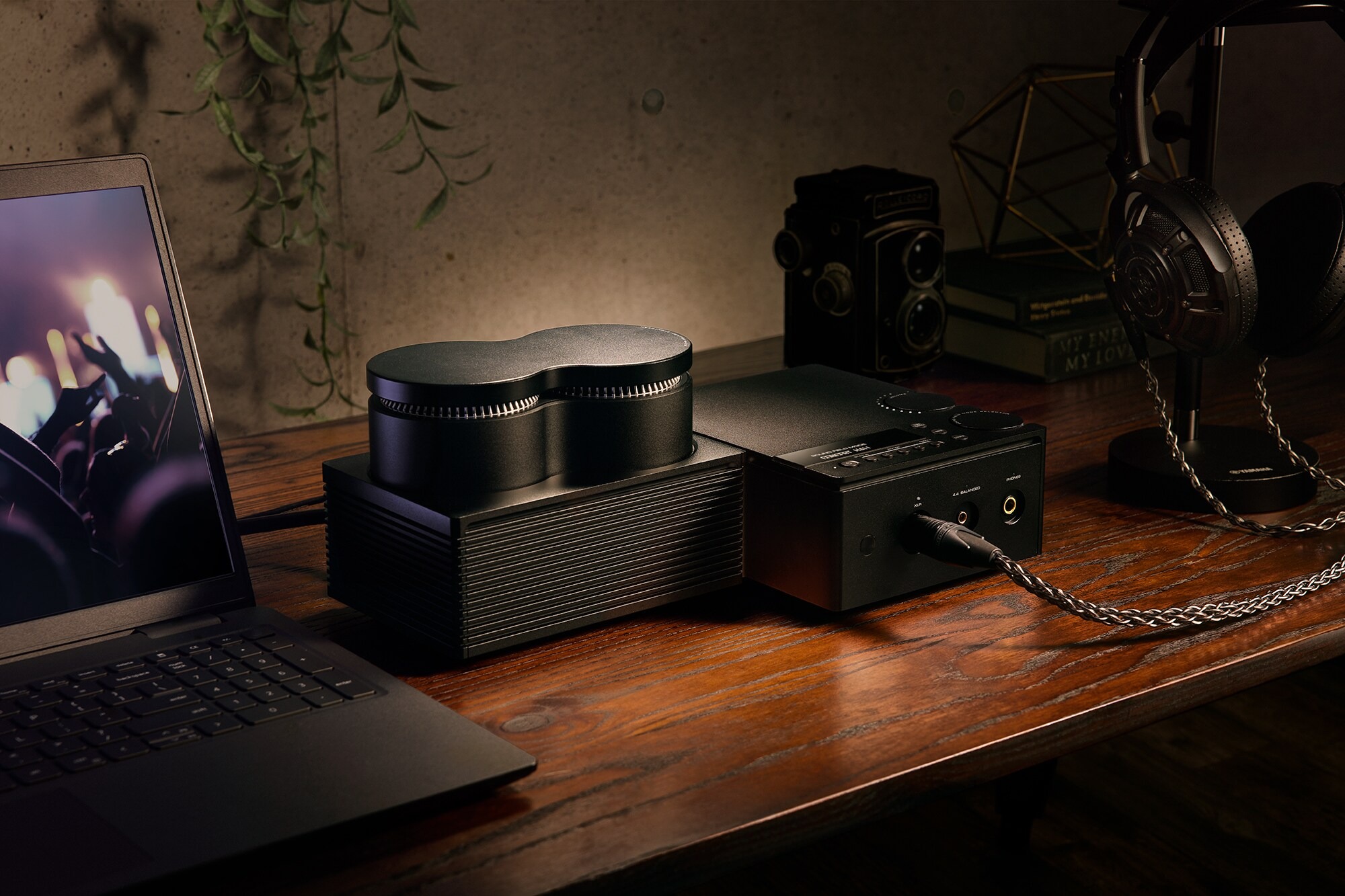 Yamaha HA-L7A headphone amplifier on a wooden desk, headphones and laptop alongside