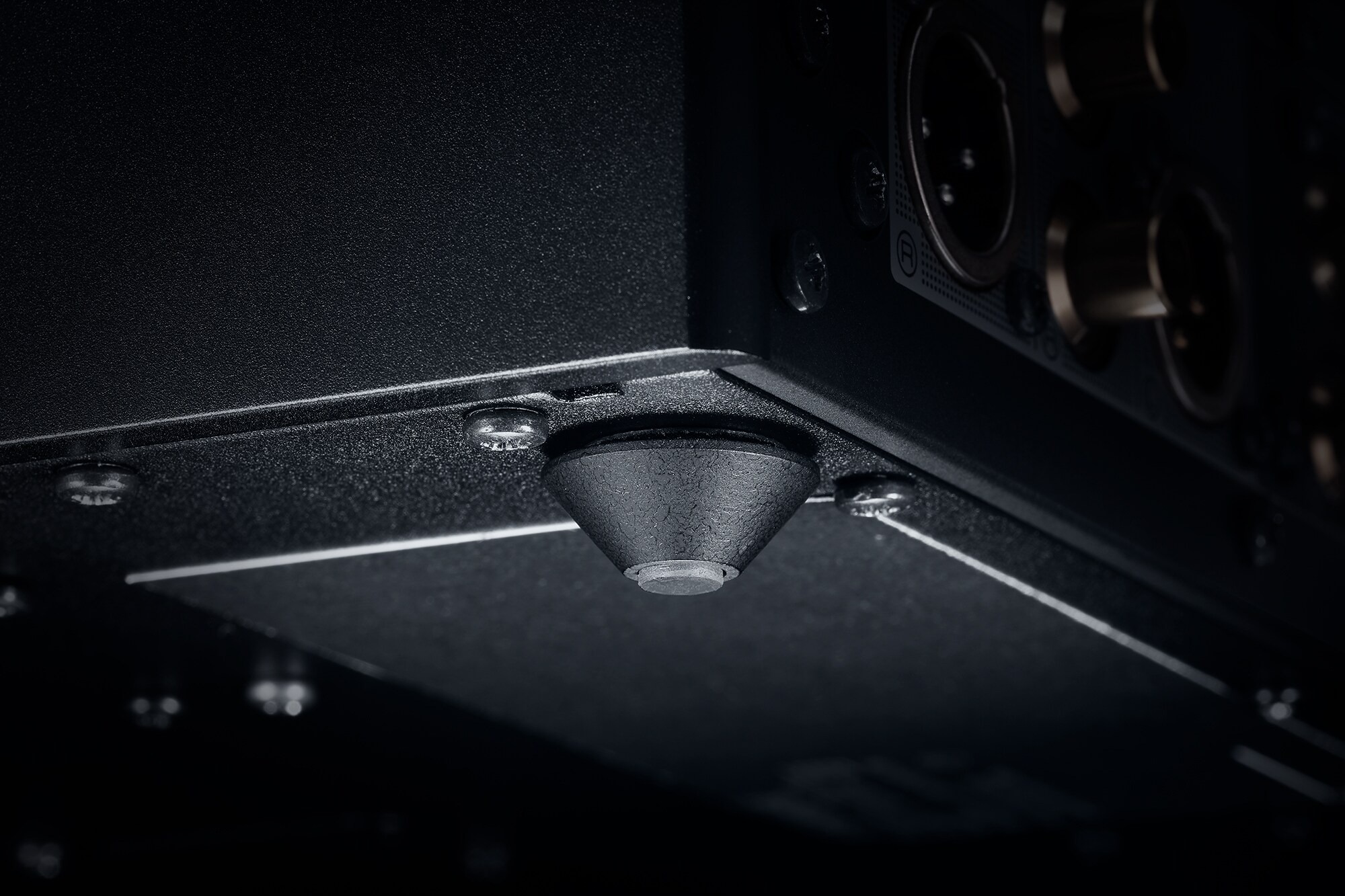 Close-up of a conical metal foot under the chassis